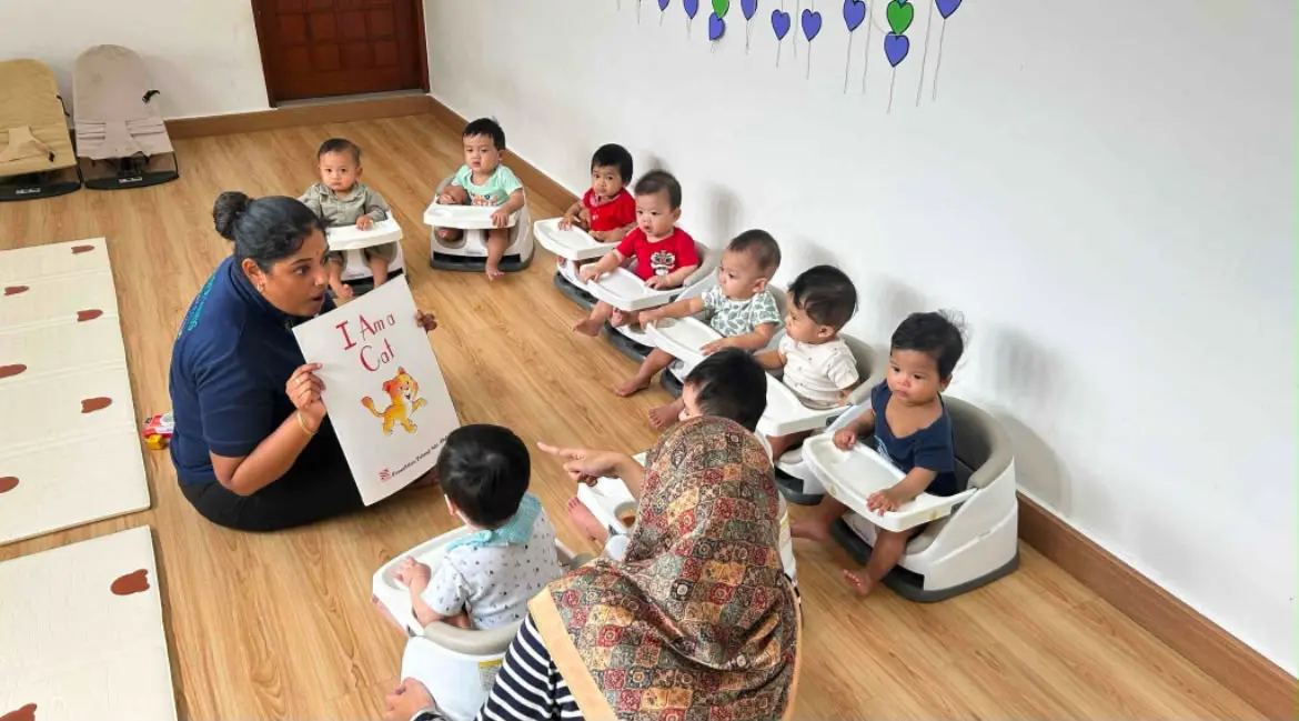 Infant care educator reading to babies