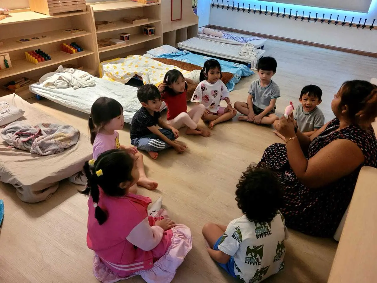 Children sitting in a circle with their teacher