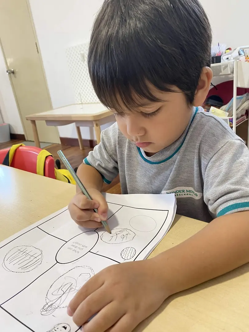 A boy writing on a worksheet