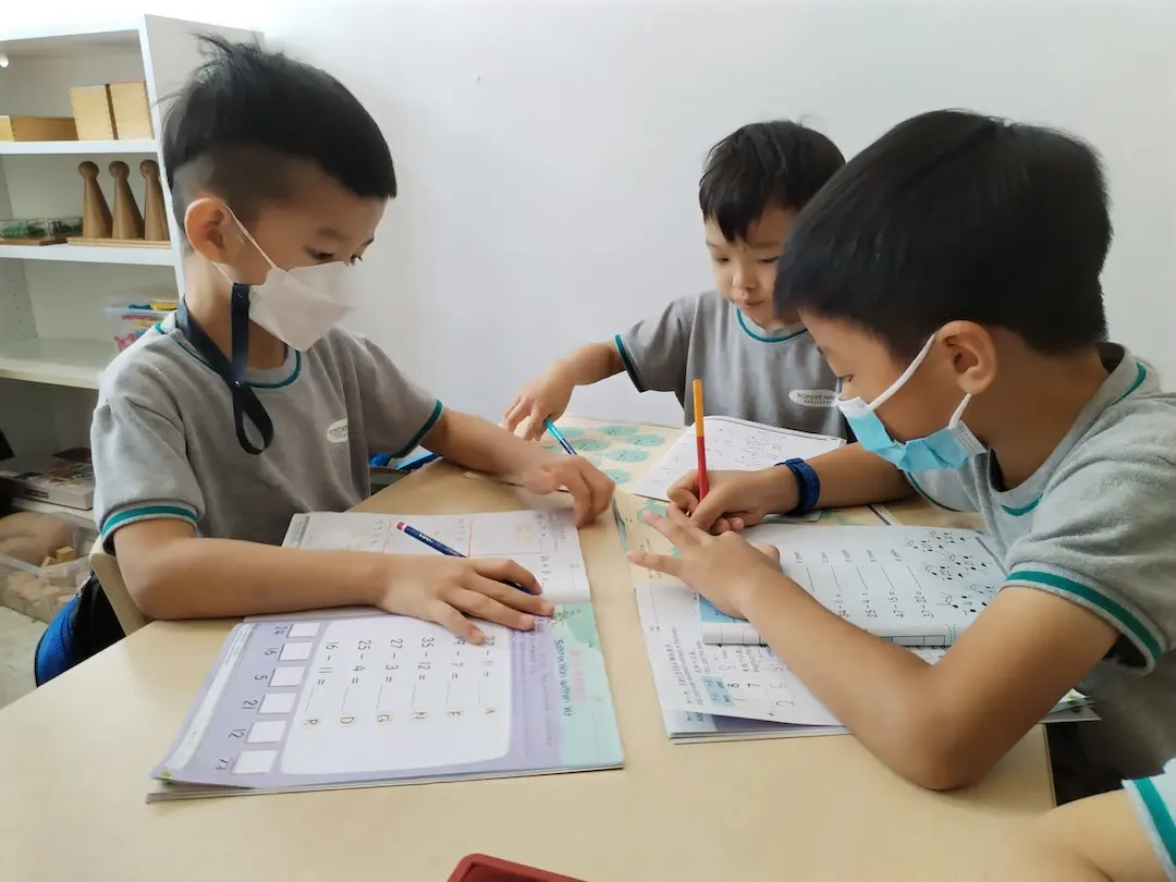Children writing in workbooks together