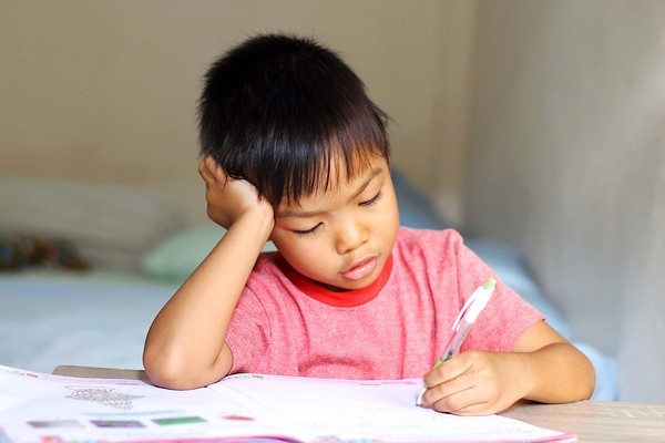 kid doing homework after class