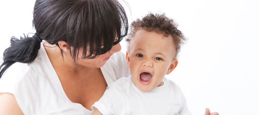 toddler laughing with mother