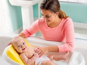mother bathing infant