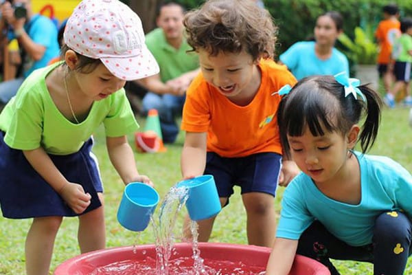 group of preschoolers playing with water